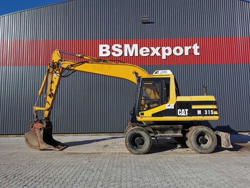 Caterpillar M315 wheel excavator - Колёсный экскаватор: фото 1 Caterpillar M315 wheel excavator - Колёсный экскаватор: фото 1