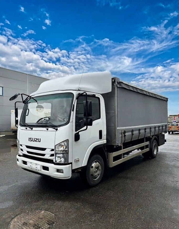 Isuzu Elf (N-series) - Тентованный грузовик: фото 1 Isuzu Elf (N-series) - Тентованный грузовик: фото 1