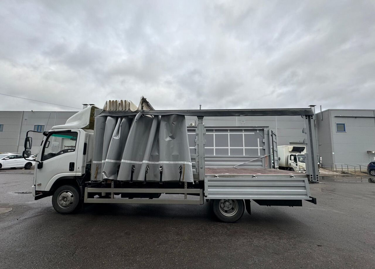 Isuzu Elf (N-series) - Тентованный грузовик: фото 1 Isuzu Elf (N-series) - Тентованный грузовик: фото 1