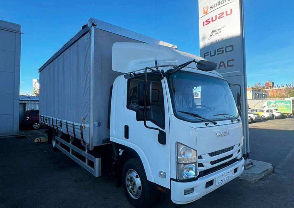 Isuzu Elf - Тентованный грузовик: фото 1 Isuzu Elf - Тентованный грузовик: фото 1