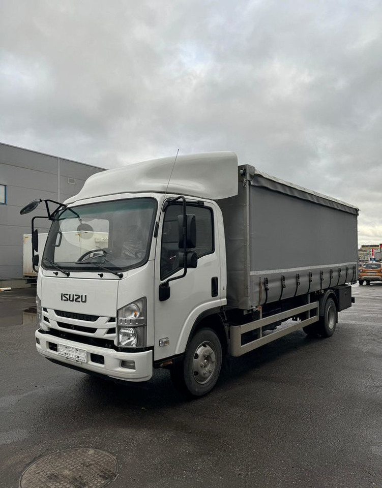 Isuzu Elf - Тентованный грузовик: фото 1 Isuzu Elf - Тентованный грузовик: фото 1